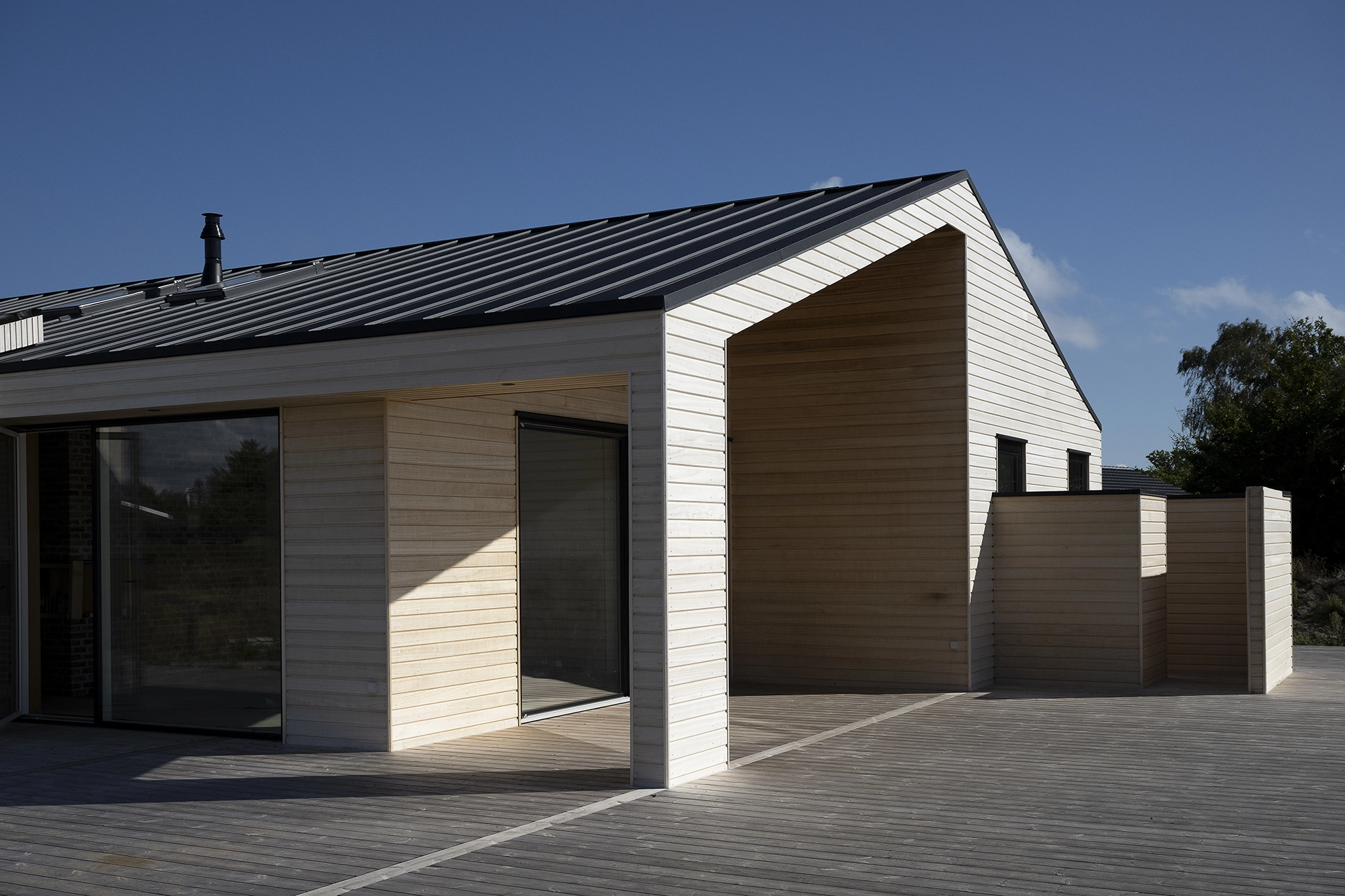 Sommerhus med vandret facade i knastfrit kiri-træ Sommerhus med vandret facadebeklædning i lyst, knastfrit kiri-træ